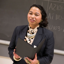 professional Asian women talking in front of a black board